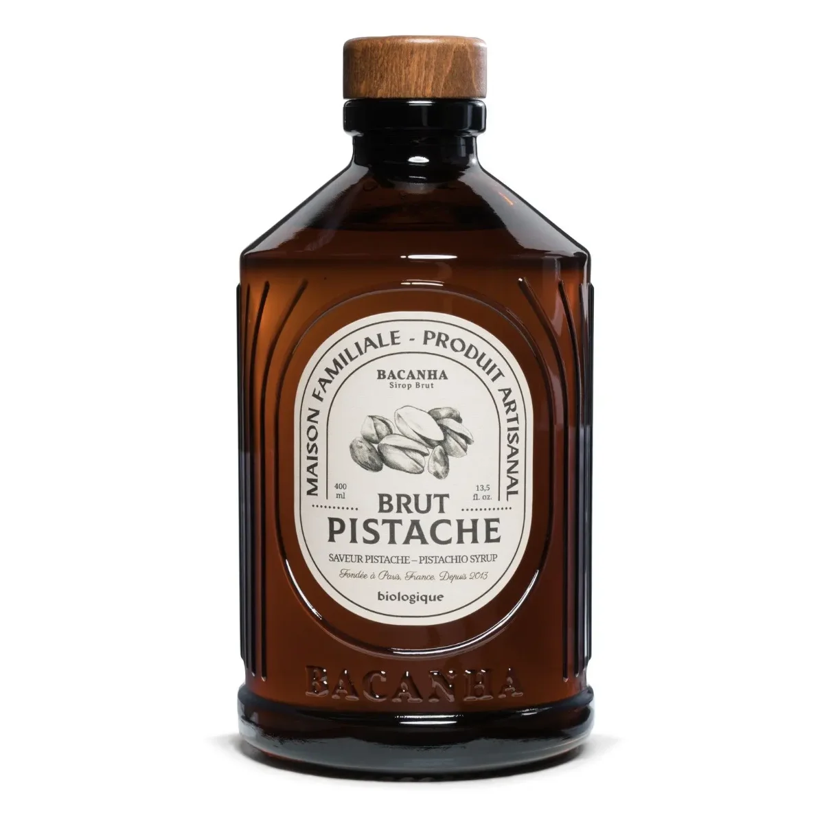Pistaziensirup in brauner Glasflasche mit Holzverschluss und Etikett, Frontalansicht