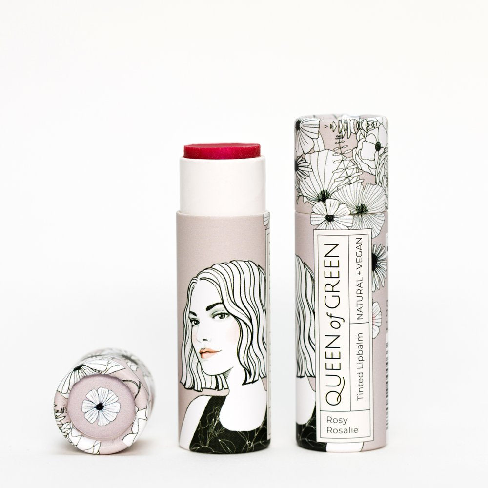 Getönter Lippenbalsam Rosy Rosalie mit roter Spitze, daneben die FSC-Kartonverpackung mit Blumenmotiv und Frauenporträt…