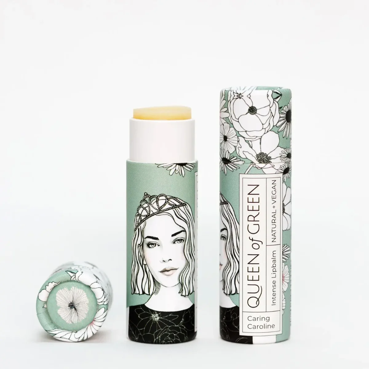 Lippenbalsam intensiv: Stift mit gelblich-cremiger Spitze und mintgrüner Papierhülse mit Frauenporträt mit Krone, daneben…