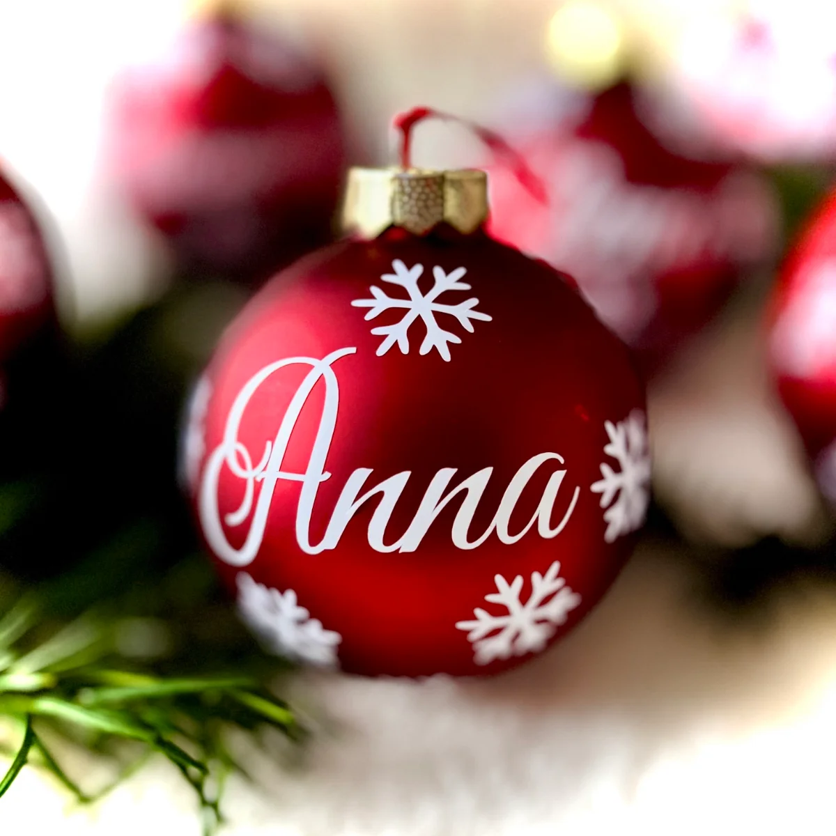 Rote Glaskugel mit weißem Namen „Anna