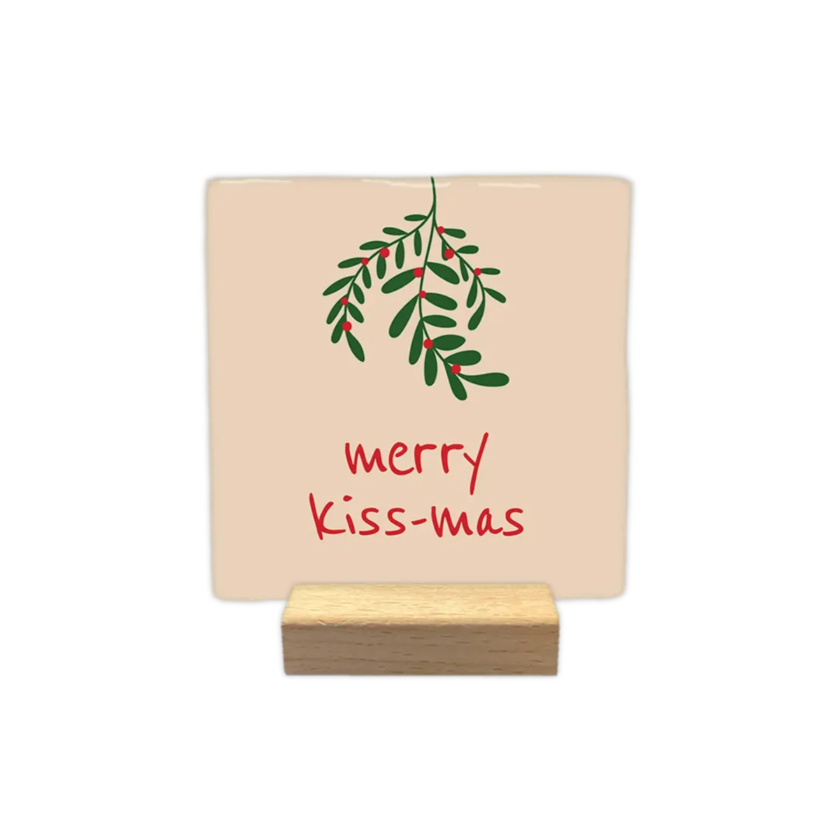 Beige Keramikfliese mit grünem Mistelzweig und rotem Text „merry kiss-mas